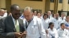 FILE - Kisumu Governor Professor Anyang Nyongo, left, talks with one of the 100 doctors from Cuba attending a program at the Kenya School of Government in Nairobi, June 11, 2018. Chinese literature is now being displayed to the public in the institution. 