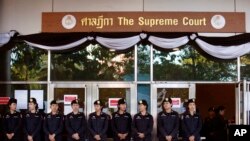 FILE - Thai police officers stand guard outside the Supreme Court in Bangkok, Sept. 27, 2017. 