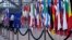 A man moves flags of European Union countries as he prepares for an upcoming EU summit at the European Council building in Brussels, March 20, 2024. 