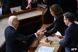 Presiden AS Joe Biden berjabat tangan dengan Wakil Presiden AS Kamala Harris di akhir pidato kenegaraannya di House Chamber di Washington, DC, pada 7 Maret 2024. (Foto: AFP)