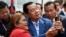 FILE - Cambodia's Prime Minister Hun Sen (C) takes selfies with a supporter during the inauguration ceremony of the Bakheng-1 water treatment plant in Phnom Penh on June 19, 2023. 