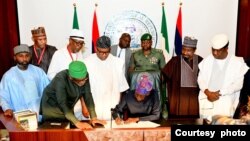 Lokacin da shugaba Tinubu yake sanya hannu kan dokar albashi mafi karanci a Abuja (Hoto: X/Dada Olusegun)