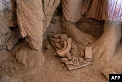 FILE - A part of a statue of Buddha is uncovered at an archaeological site in Mes Aynak, in the eastern province of Logar, May 17, 2022.
