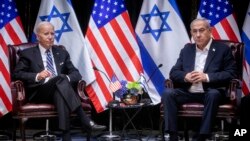FILE - U.S. President Joe Biden, left, pauses during a meeting with Israeli Prime Minister Benjamin Netanyahu, in Tel Aviv, Israel, Oct. 18, 2023.