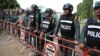 FILE - Cambodian police man a barricade outside a prison in Trapaing Phlong in Tbong Khmum province on September 11, 2017, where opposition leader Kem Sokha is being held after being detained last week.