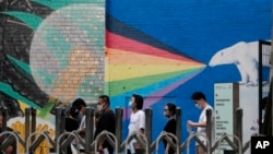 FILE - Visitors to the U.S. consular service line up outside the U.S. embassy in Beijing, Aug. 1, 2022. The Chinese government has protested to the United States over the treatment of Chinese arriving to study in America.