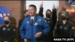 In this still image taken from a July 6, 2024, NASA TV broadcast, NASA astronaut and deputy director Flight Operations Kjell Lindgren, center, speaks as crew members exit the Mars habitat in Houston, Texas.
