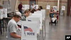 FILE - Voters cast ballots in a primary election in Billings, Montana, June 4, 2024.