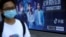 FILE - A pedestrian wearing a face mask following the coronavirus disease (COVID-19) outbreak walks past an advertisement of TikTok (Douyin) at a bus stop in Beijing, China Aug. 24, 2020.