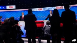 Photographers take photos of President Joe Biden, right, and Republican presidential candidate former President Donald Trump, left, during a break in a presidential debate hosted by CNN, June 27, 2024, in Atlanta. 