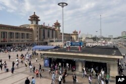 Lalu lalang wisatawan di Stasiun Kereta Api Beijing, Jumat, 29 September 2023. (AP/Andy Wong)