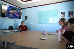 This photo taken on June 14, 2024 shows Black Turtle Dive conservation teacher Sandra Rubio (L) teaching coral conservation to her students in the Black Turtle Dive classroom in Koh Tao island in the southern Thai province of Surat Thani.