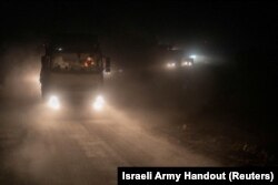 A truck containing humanitarian aid from the World Food Program moves in a location given as northern Gaza Strip, in this handout image released March 12, 2024.