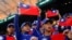FILE - Baseball players hold the Taiwanese flag while waiting for the match between Taiwan and Panama in the 2023 World Baseball Classic game in Taichung, Taiwan March 8, 2023. 