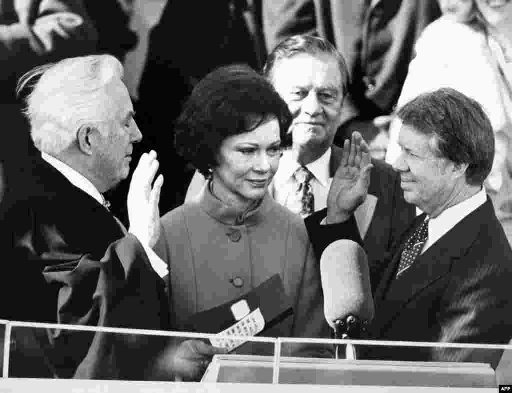Chief Justice Warren Burger administers the oath of office to Jimmy Carter (R) as the 39th President of the United Sates, at the Capitol in Washington, D.C., Jan. 20, 1977.