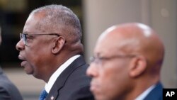 FILE - U.S. Secretary of Defense Lloyd Austin, left, and Chairman of the Joint Chiefs of Staff Air Force Gen. Charles Brown, participate in a virtual Ukraine Defense Contact Group meeting at the Pentagon, outside Washington, Nov. 22, 2023.