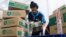 FILE - An employee prepares packages for shipping at a warehouse of e-commerce giant Tokopedia in Jakarta, Indonesia, Aug. 31, 2022. 