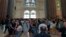 Visitors look around the main temple of the Sagrada Familia, Oct. 6, 2023. (Graham Keeley/VOA)