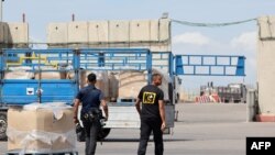 FILE - Trucks carrying humanitarian aid slated for Gaza await clearance at the Kerem Shalom (Karm Abu Salem) border crossing on March 14, 2024 amid the ongoing conflict between Israel and the Palestinian militant group Hamas. 