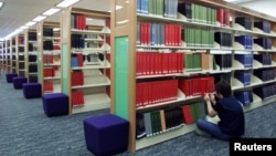 FILE - A library worker indexes periodicals at the Hong Kong Central Library May 14, 2001.