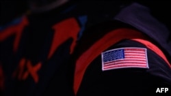 The new spacesuit, with a US flag patch, is seen during the Axiom Space Artemis III Lunar Spacesuit event at Space Center Houston in Houston, Texas, on March 15, 2023.