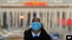 A soldier dressed as an usher stands guard at an entrance door of the Great Hall of the People in Beijing, March 3, 2023.