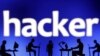Foto ilustrasi yang menunjukkan kumpulan manusia dengan laptop dan telepon genggamnya di depan tulisan "hacker." Foto diambil pada 19 Februari 2024. (Foto: Reuters/Dado Ruvic)