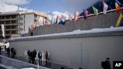 People arrive at the Davos Congress Center where the World Economic Forum takes place in Davos, Switzerland, Jan. 15, 2024. The annual meeting of the World Economic Forum is taking place in Davos runs until Jan. 19, 2024.