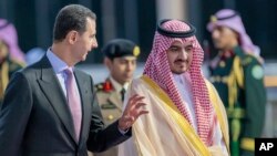 In this photo provided by Saudi Press Agency, SPA, Syrian President Bashar Assad, is accompanied by Prince Badr Bin Sultan, deputy governor of Mecca, May 18, 2023, ahead of the Arab summit. 