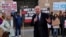 British lawmaker Iain Duncan Smith and human rights campaigner Helena Kennedy, left, join activists and community members as they protest outside the British Foreign Office in central London, Feb. 13, 2023. 