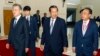 FILE - Cambodia's Prime Minister Hun Sen, center, walks together with South Korea President Moon Jae-in, left, as Cambodian tycoon Kith Meng, right, accompanies them before a business forum at the Peace Palace, in Phnom Penh, Cambodia, March 15, 2019. 