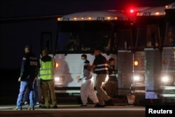 A Venezuelan migrant walks to board a repatriation flight, as a part of an immigration enforcement process, at the airport in Harlingen, Texas, Oct. 18, 2023.
