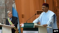 FILE - U.N. Secretary-General Antonio Guterres listens as Niger President Mohamed Bazoum speaks at the presidential palace in Niamey on May 2, 2022. Guterres "strongly condemns the unconstitutional change in government" in Niger, his spokesman said July 26, 2023, after Bazoum was deposed in a coup.