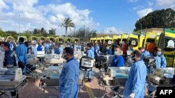 Sejumlah petugas medis asal Mesir tampak bersiap dengan inkubator yang mereka bawa di perbatasan Rafah, pada 20 November 2023. Inkubator tersebut disiapkan untuk sejumlah bayi prematur yang dievakuasi dari Gaza ke Mesir. (Foto: AFP)