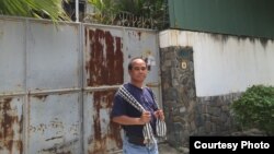 Reasey Poch standing in front of his father's house in Phnom Penh, Cambodia in 2017.