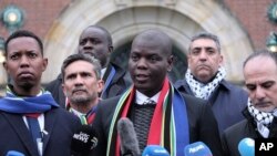 South Africa's Minister of Justice and Correctional Services Ronald Lamola, center, and Palestinian assistant Minister of Multilateral Affairs Ammar Hijazi, right, speak outside the International Court of Justice in The Hague, Netherlands, Jan. 11, 2024.