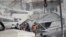 Emergency services work at a building hit by an air strike in Damascus, Syria, Jan. 20, 2024. Syrian and Iranian state media say an Israeli strike on the Syrian capital killed five Iranian advisers. 