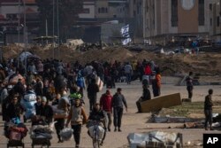 Palestinians flee an Israeli ground offensive in Kahn Younis, Gaza Strip, Jan. 27, 2024.