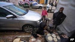 Palestinians displaced by the Israeli bombardment of the Gaza Strip prepare bread in a UNDP-provided tent camp in Khan Younis, Nov.15, 2023.