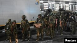 Fighters of Wagner private mercenary group pull out of the headquarters of the Southern Military District to return to base, in the city of Rostov-on-Don, Russia, June 24, 2023.
