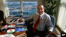 FILE - Manuel Rocha sits in his office at Steel Hector & Davis in Miami in January 2003.
