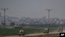 Israeli soldiers move near the Israeli-Gaza border as seen from southern Israel, Jan. 8, 2024.