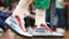 FILE - Enes Kanter Freedom wore these shoes urging that China not host the 2022 Winter Olympic Games when the Boston Celtics hosted the Chicago Bulls in Boston, Nov 1, 2021.