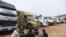 FILE - Truck drivers gather at a makeshift parking lot where Vietnamese container trucks are waiting to cross the Vietnam-China border in Lang Son province on Jan. 7, 2022.