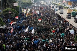 People gather outside the Indonesian Parliament building during a protest against planned controversial revisions to election law in Jakarta on Aug. 22, 2024.