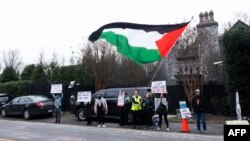 Protesters call for a cease-fire in the Israel-Hamas war as they demonstrate outside the home of US Secretary of State Antony Blinken in Arlington, Virginia, on Jan. 27, 2024.