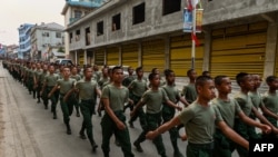 FILE - This photo taken on April 17, 2019, shows United Wa State Army (UWSA) soldiers walking during a ceremony in Panghsang to commemorate 30 years of a ceasefire signed with the Myanmar military in the Wa State.