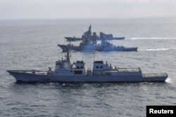 FILE - South Korean Navy destroyer Yulgok Yi I, U.S. Navy destroyer USS Benfold and Japan Self-Defense Force destroyer Atago take part in joint naval missile defense exercises in international waters between Korea and Japan, April 17, 2023.