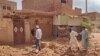 People check a damaged house in southern Khartoum on June 12, 2023, as deadly shelling and gunfire resumed after the end of a 24-hour cease-fire in Sudan.