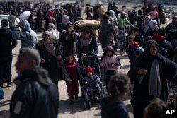 After fleeing an Israeli ground and air offensive in nearby Khan Younis, Palestinians arrive in the southern Gaza town of Rafah, Jan. 26, 2024.